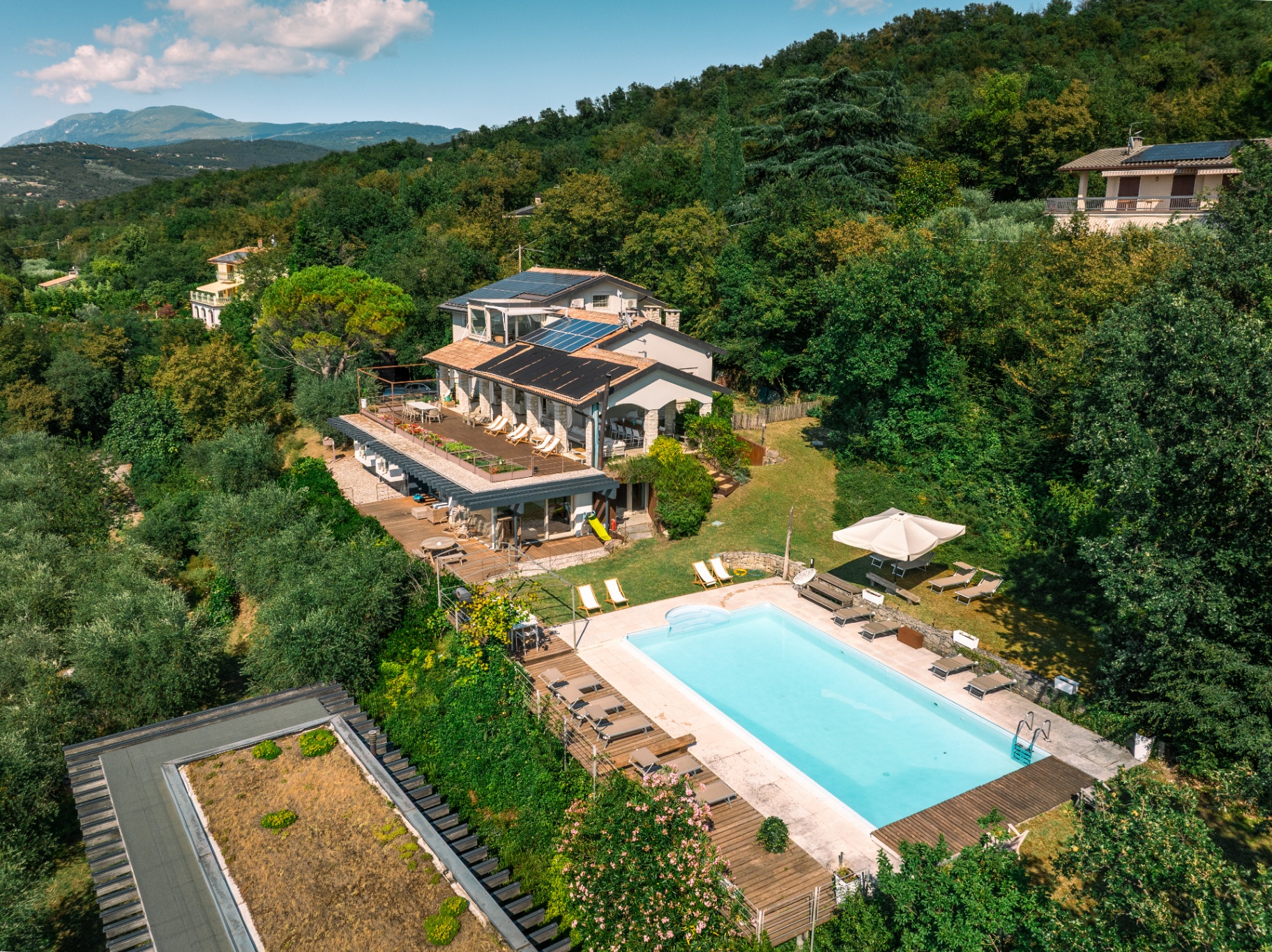 Aerial summer view of the villa, pool and terraces