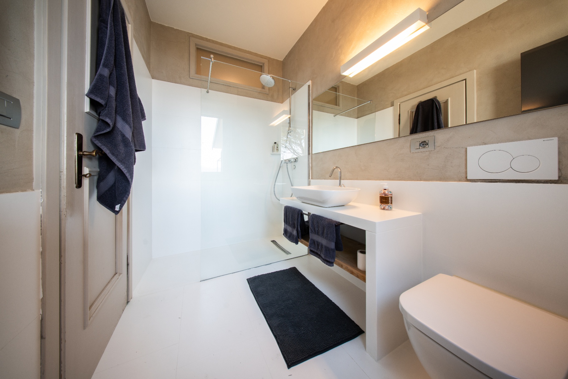 Modern walk-in shower room with vessel basin