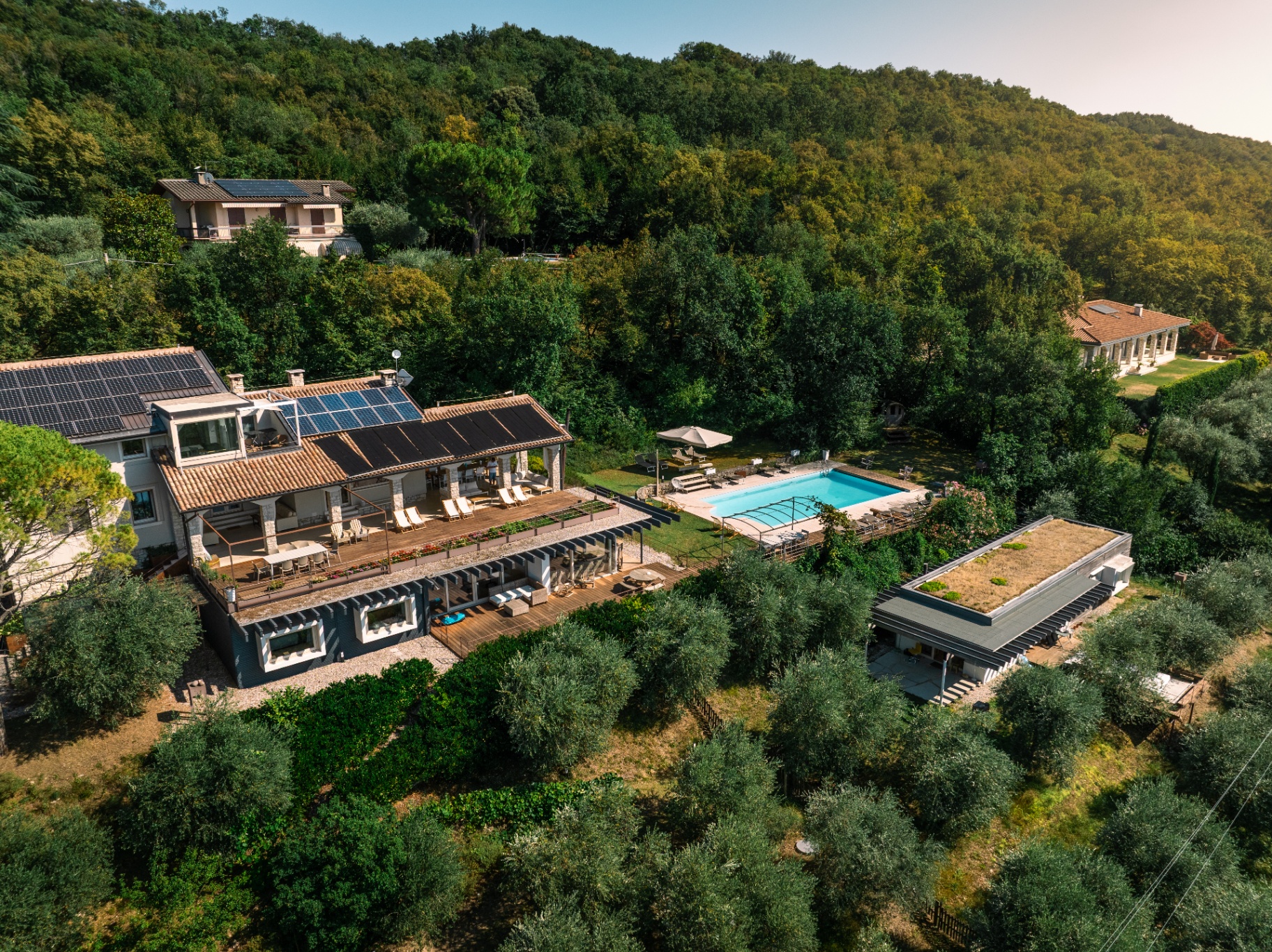 Summer aerial of the villa, pool terrace and gardens
