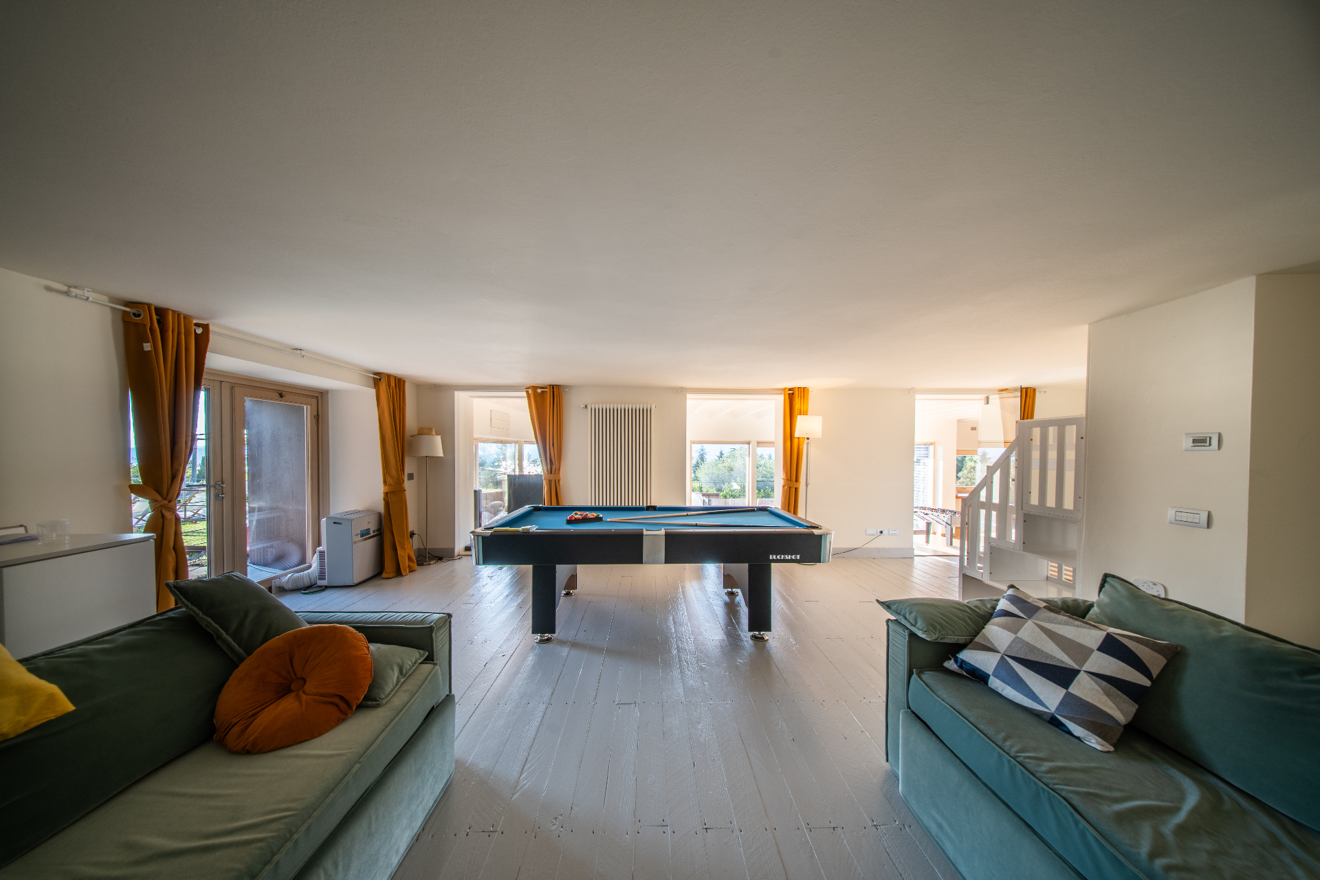 Games room with pool table, foosball and lounge seating