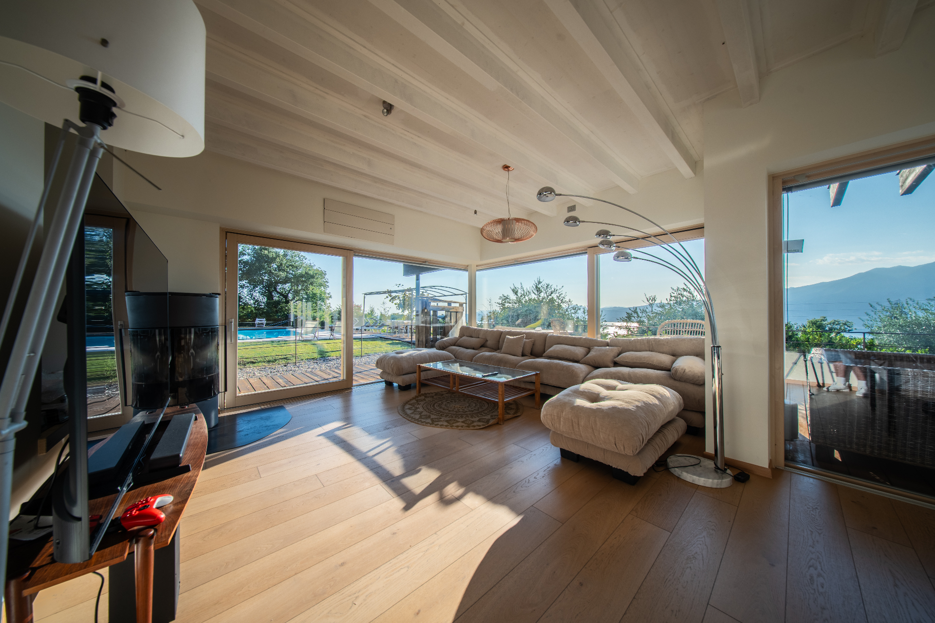 Downstairs lounge with log burner opening onto the pool terrace