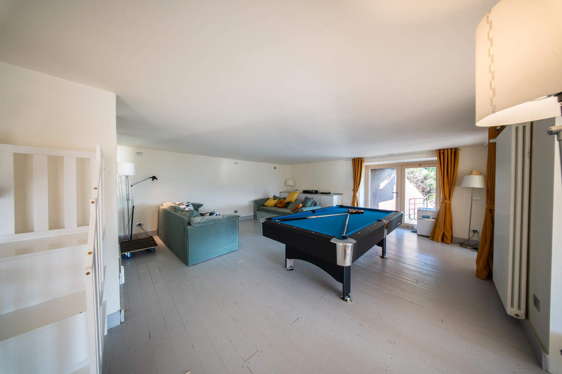 Games room with pool table, velvet sofas and garden doors